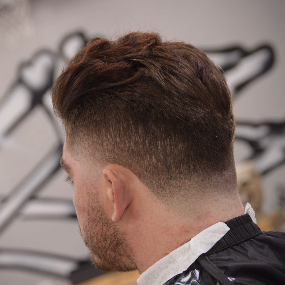 Textured cut with a skin fade at Boneyard Barbering