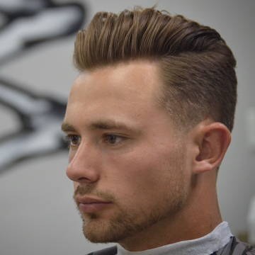 Brushed back pompadour with low fade, side view