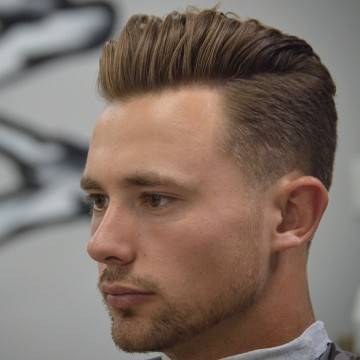 Brushed back pompadour with low fade, three-quarter view