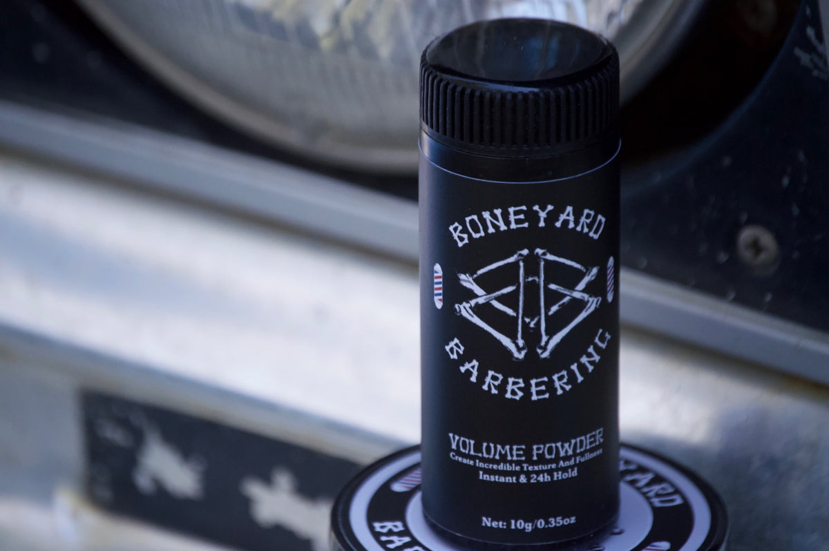 Boneyard Volume Powder bottle on a tree stump